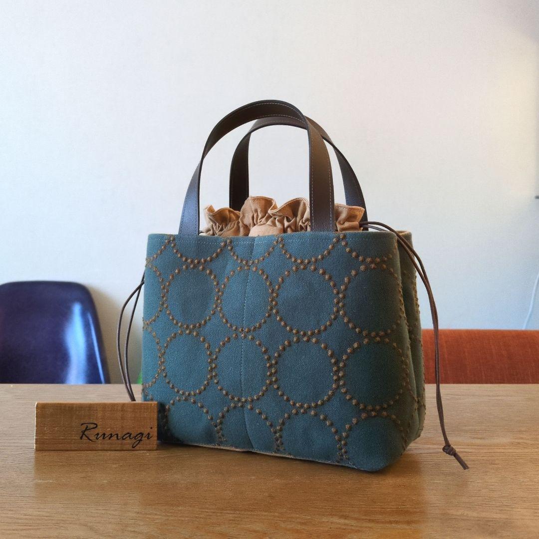 あおりポケットの巾着バッグ＊ミナペルホネン