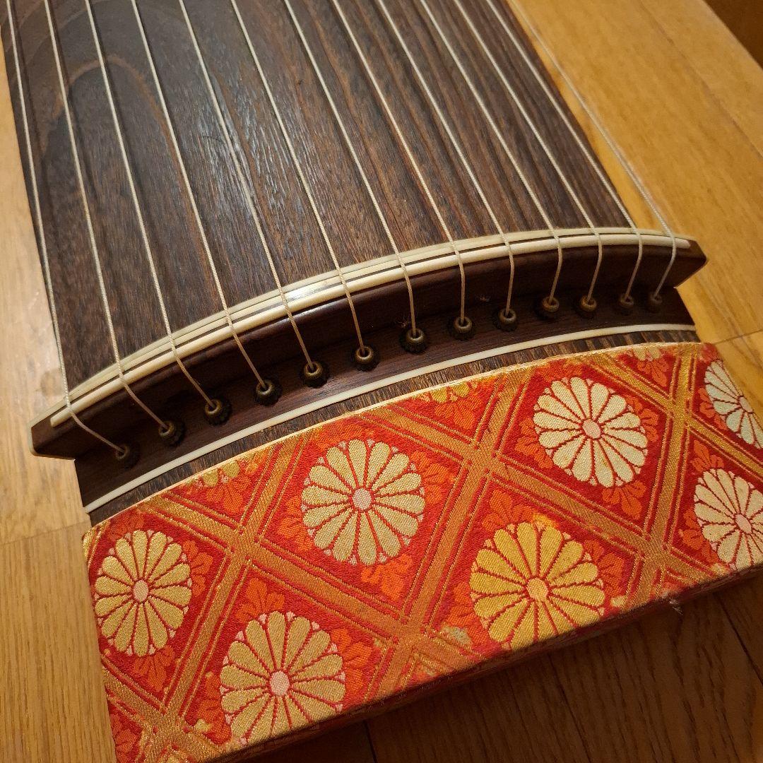 オレンジ色の鶴模様の袋つき　　　お琴