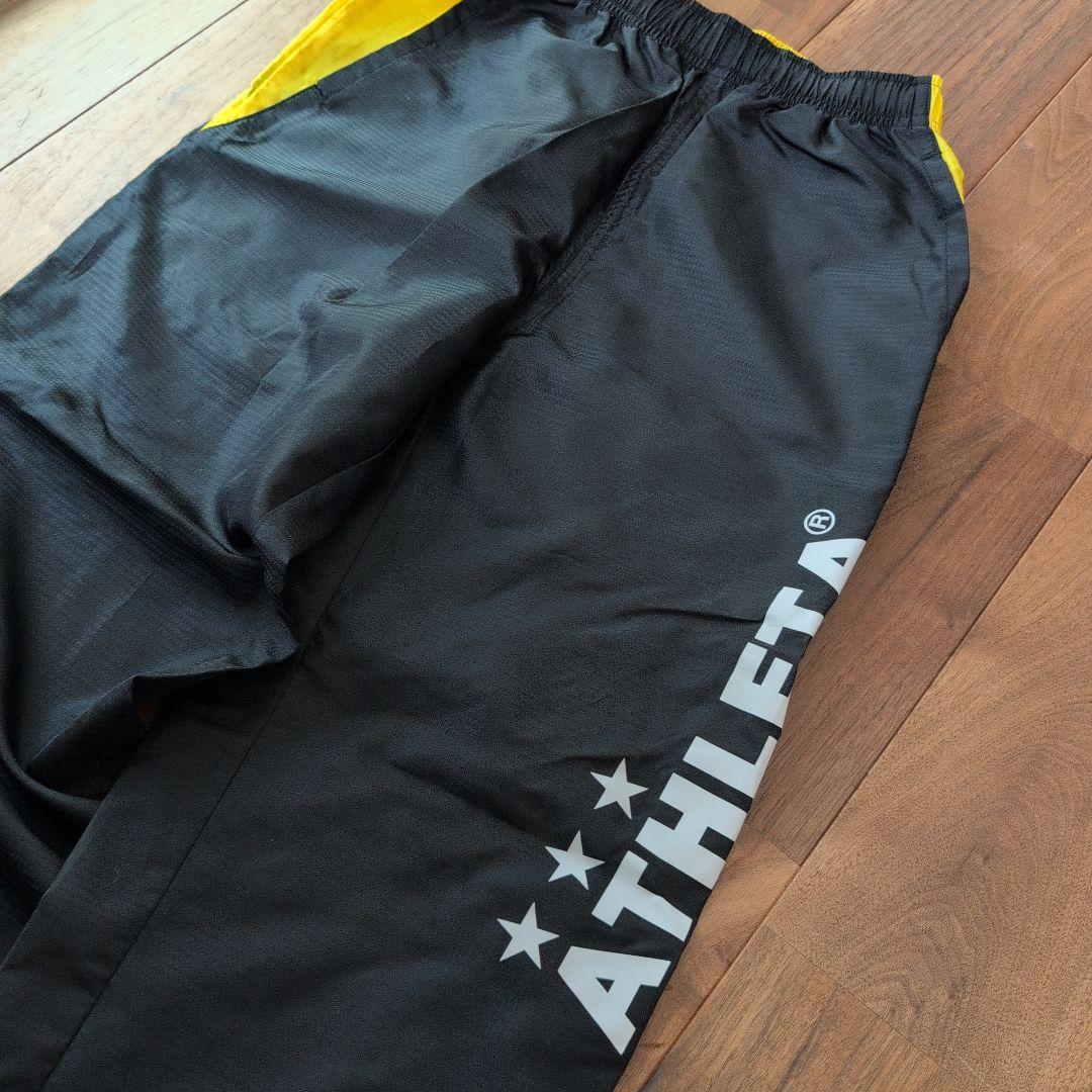 ATHLETA ピステ上下セット 150 黒/黄色